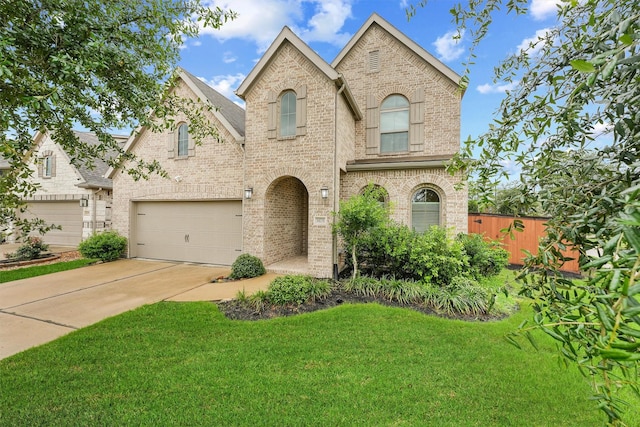 14251 Archer County Trl, Cypress, TX 77429 - french country style house with brick siding, a garage, driveway, and a shingled roof