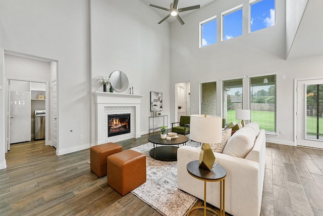 14251 Archer County Trl, Cypress, TX 77429 - living area with a high ceiling, ceiling fan, a tile fireplace, healthy amount of natural light, and wood finished floors