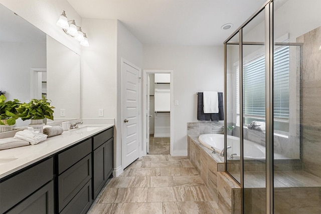 14251 Archer County Trl, Cypress, TX 77429 - bathroom with double vanity, a garden tub, a shower stall, and a walk in closet