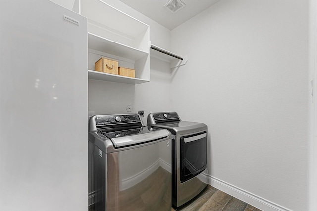 14251 Archer County Trl, Cypress, TX 77429 - washroom featuring separate washer and dryer and dark wood-style flooring