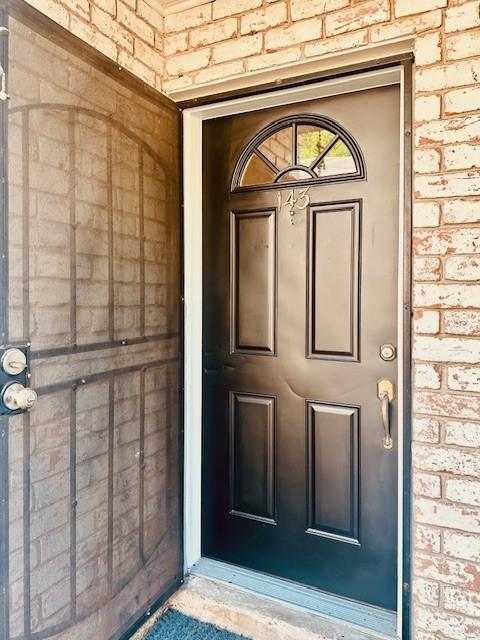 7900 Westheimer Rd Unit 143, Houston, TX 77063 - doorway to property featuring brick siding