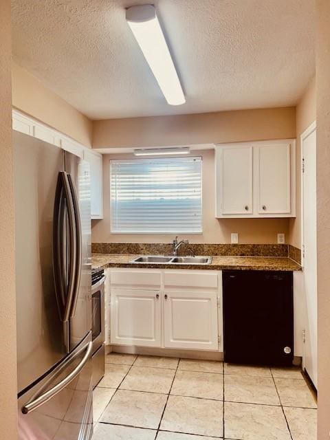 7900 Westheimer Rd Unit 143, Houston, TX 77063 - kitchen featuring appliances with stainless steel finishes, a textured ceiling, white cabinets, dark countertops, and light tile patterned floors