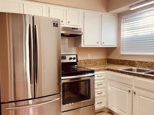 7900 Westheimer Rd Unit 143, Houston, TX 77063 - kitchen featuring appliances with stainless steel finishes, under cabinet range hood, white cabinetry, and dark countertops