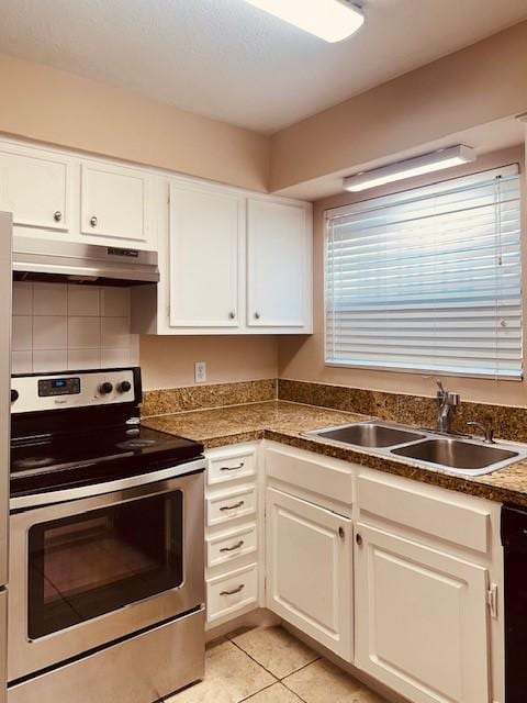 7900 Westheimer Rd Unit 143, Houston, TX 77063 - kitchen with stainless steel electric range, under cabinet range hood, white cabinets, light tile patterned floors, and dishwashing machine