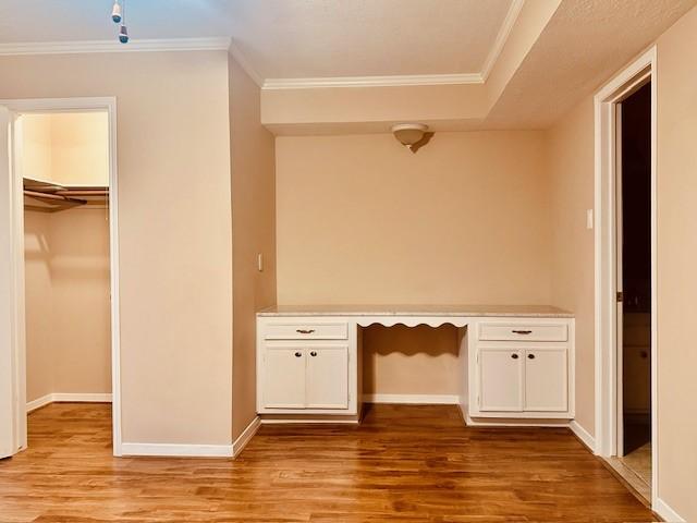 7900 Westheimer Rd Unit 143, Houston, TX 77063 - unfurnished office with built in study area, light wood-style flooring, and crown molding