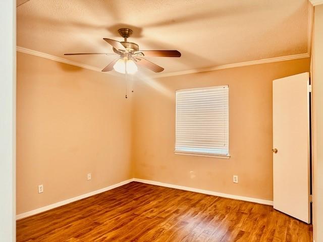 7900 Westheimer Rd Unit 143, Houston, TX 77063 - unfurnished room featuring wood finished floors, ornamental molding, and a ceiling fan