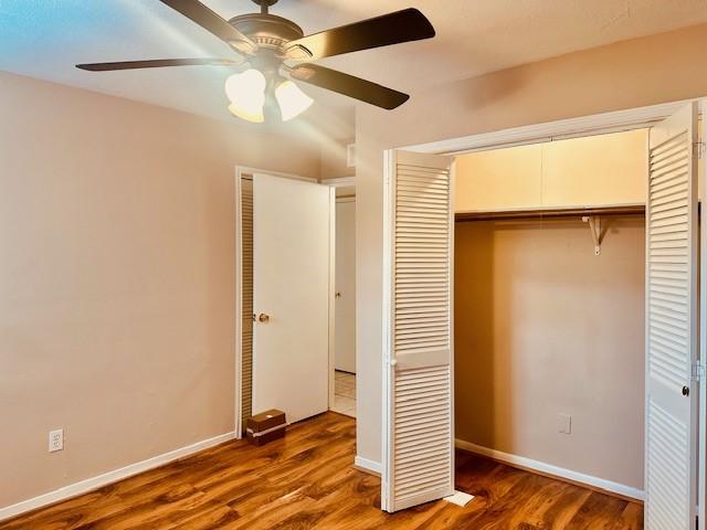 7900 Westheimer Rd Unit 143, Houston, TX 77063 - unfurnished bedroom featuring wood finished floors, a ceiling fan, and a closet