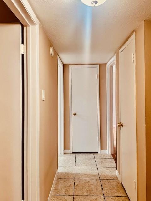 7900 Westheimer Rd Unit 143, Houston, TX 77063 - hall featuring light tile patterned flooring and a textured ceiling