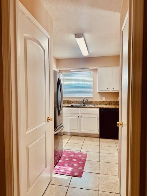 7900 Westheimer Rd Unit 143, Houston, TX 77063 - laundry area with light tile patterned floors and a textured ceiling