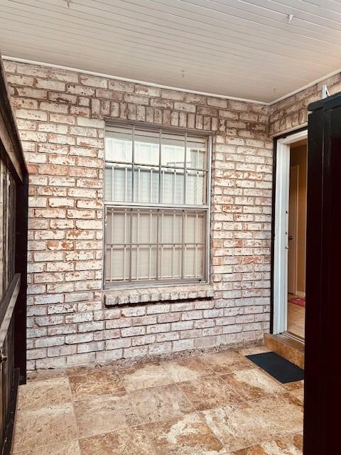 7900 Westheimer Rd Unit 143, Houston, TX 77063 - spare room with brick wall