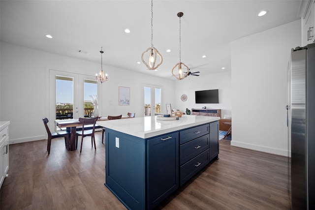 22831 Cuadro St, Galveston, TX 77554 - kitchen featuring a chandelier, freestanding refrigerator, blue cabinetry, recessed lighting, and dark wood-type flooring