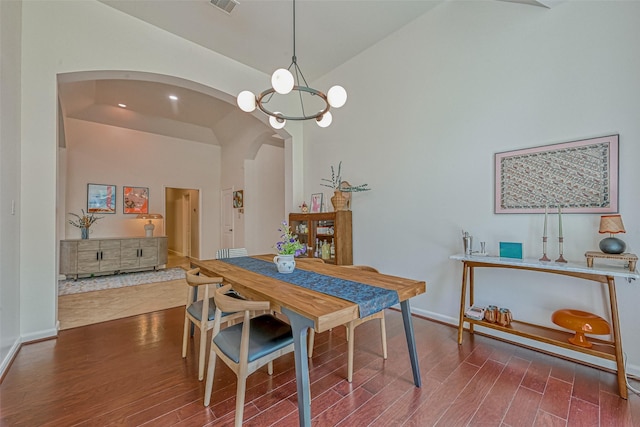 5918 Emmit Creek Ln, Sugar Land, TX 77479 - dining room with arched walkways, wood finished floors, high vaulted ceiling, and recessed lighting