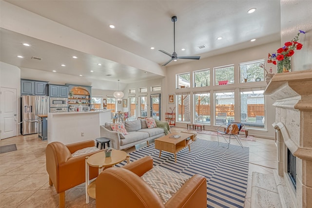 5918 Emmit Creek Ln, Sugar Land, TX 77479 - living area with a fireplace, recessed lighting, a ceiling fan, and light tile patterned flooring