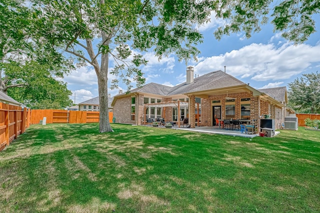 5918 Emmit Creek Ln, Sugar Land, TX 77479 - back of property featuring brick siding, a chimney, a fenced backyard, a patio, and roof with shingles