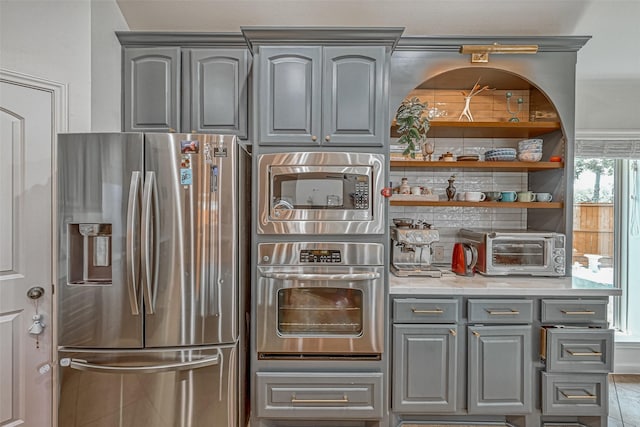 5918 Emmit Creek Ln, Sugar Land, TX 77479 - kitchen with appliances with stainless steel finishes, gray cabinets, light countertops, and open shelves
