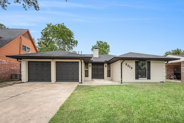 8419 Sterlingshire St, Houston, TX 77078 - view of front of house featuring driveway, a garage, a chimney, a front yard, and brick siding