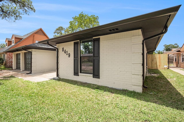 8419 Sterlingshire St, Houston, TX 77078 - back of house featuring brick siding and a gate