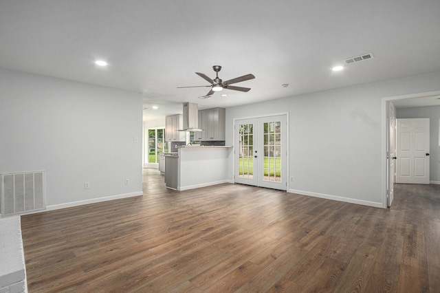 8419 Sterlingshire St, Houston, TX 77078 - unfurnished living room with french doors, a ceiling fan, plenty of natural light, dark wood-type flooring, and recessed lighting