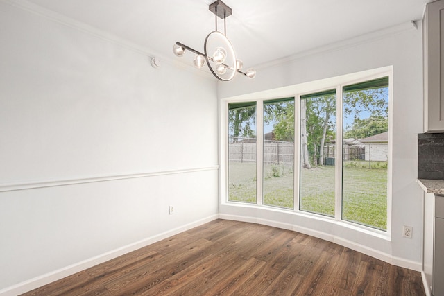 8419 Sterlingshire St, Houston, TX 77078 - unfurnished dining area featuring ornamental molding, a chandelier, and dark wood-type flooring