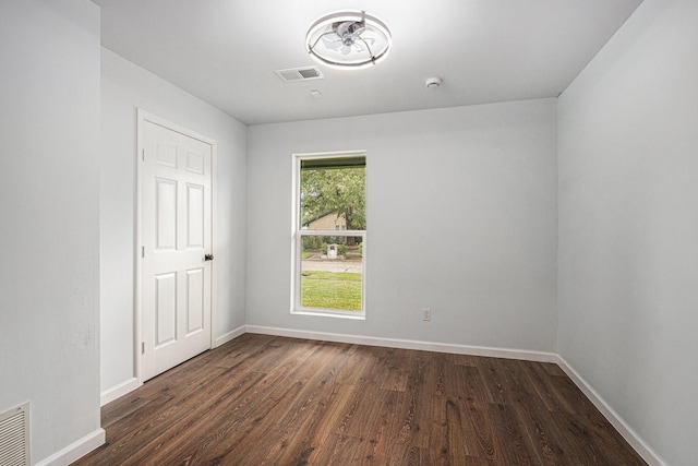 8419 Sterlingshire St, Houston, TX 77078 - spare room with dark wood-style floors and a smoke detector