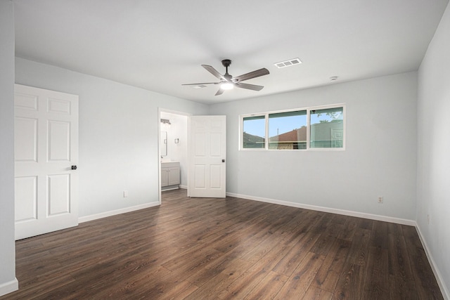 8419 Sterlingshire St, Houston, TX 77078 - unfurnished bedroom with dark wood-style floors, ceiling fan, and connected bathroom