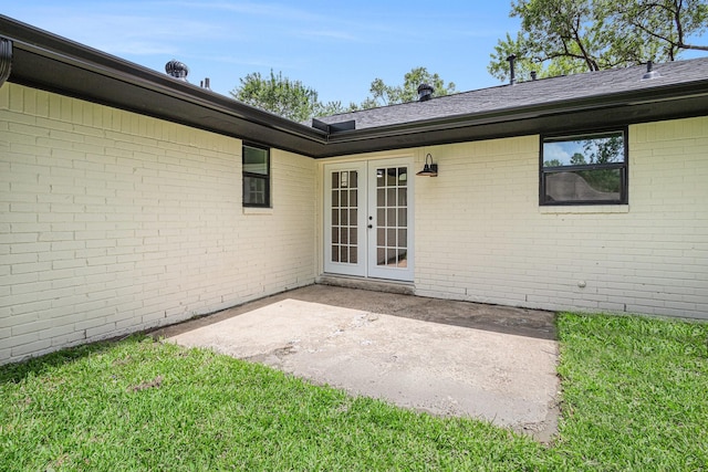 8419 Sterlingshire St, Houston, TX 77078 - property entrance featuring french doors, a patio, brick siding, and a lawn