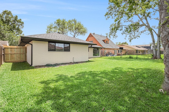 8419 Sterlingshire St, Houston, TX 77078 - back of property featuring a fenced backyard, brick siding, and a shingled roof