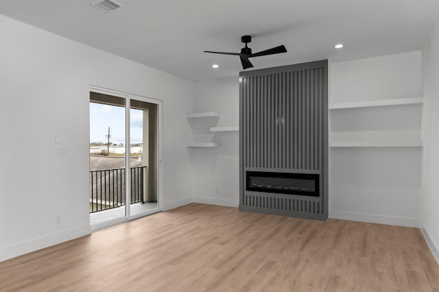 1803 Sakowitz St, Houston, TX 77020 - unfurnished living room with a ceiling fan, wood finished floors, recessed lighting, and a glass covered fireplace