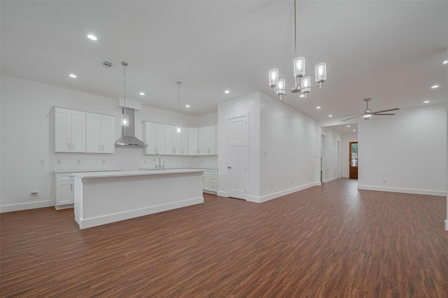515 Briarcliff Dr, Houston, TX 77076 - kitchen with wall chimney range hood, recessed lighting, ceiling fan, dark wood finished floors, and white cabinetry