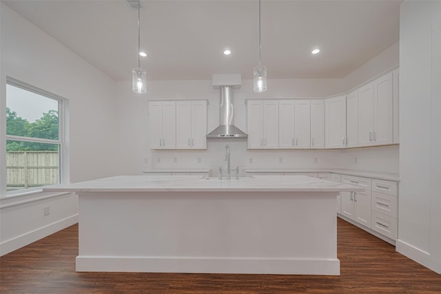 515 Briarcliff Dr, Houston, TX 77076 - kitchen featuring a center island with sink, white cabinets, wall chimney range hood, pendant lighting, and recessed lighting