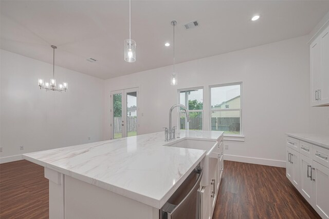 515 Briarcliff Dr, Houston, TX 77076 - kitchen with dark wood-style floors, dishwasher, light stone countertops, an island with sink, and white cabinets