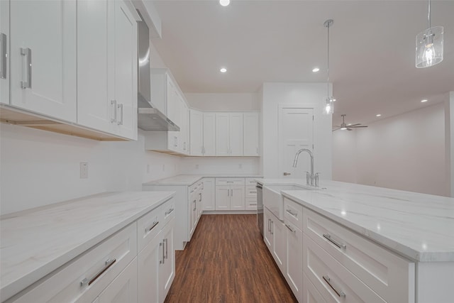 515 Briarcliff Dr, Houston, TX 77076 - kitchen featuring wall chimney range hood, light stone counters, dark wood-style flooring, white cabinets, and recessed lighting