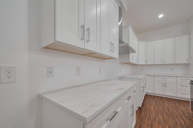 515 Briarcliff Dr, Houston, TX 77076 - kitchen with wall chimney range hood, dark wood-style floors, white cabinetry, light stone countertops, and recessed lighting