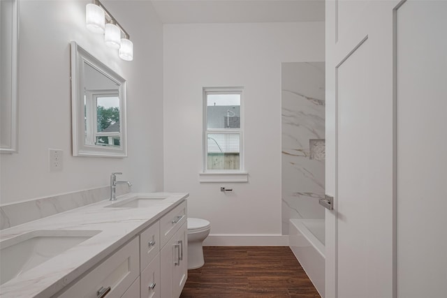 515 Briarcliff Dr, Houston, TX 77076 - bathroom featuring double vanity, wood finished floors, and washtub / shower combination