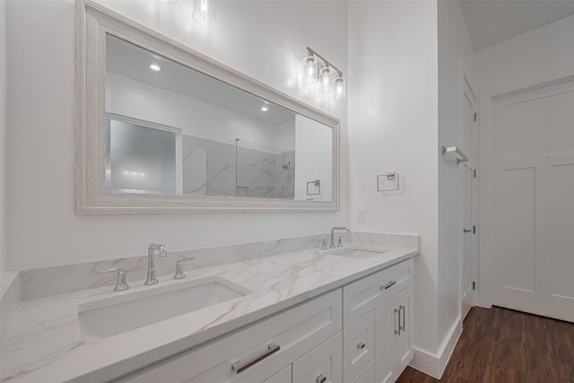 515 Briarcliff Dr, Houston, TX 77076 - bathroom with a marble finish shower, double vanity, and wood finished floors