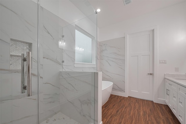 515 Briarcliff Dr, Houston, TX 77076 - full bathroom with a marble finish shower, vanity, a soaking tub, and wood finished floors
