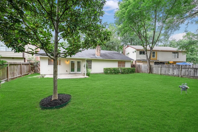 2110 Trailing Vine Rd, Spring, TX 77373 - rear view of house with french doors, a chimney, and a fenced backyard