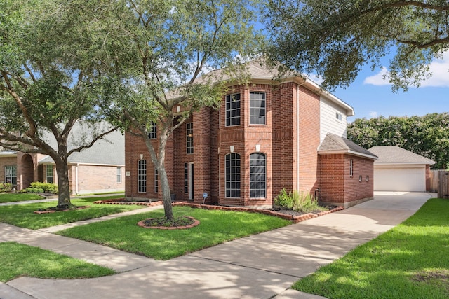 13826 Swan Hollow Ln, Houston, TX 77041 - view of front of house with brick siding, a front yard, a detached garage, roof with shingles, and an outbuilding