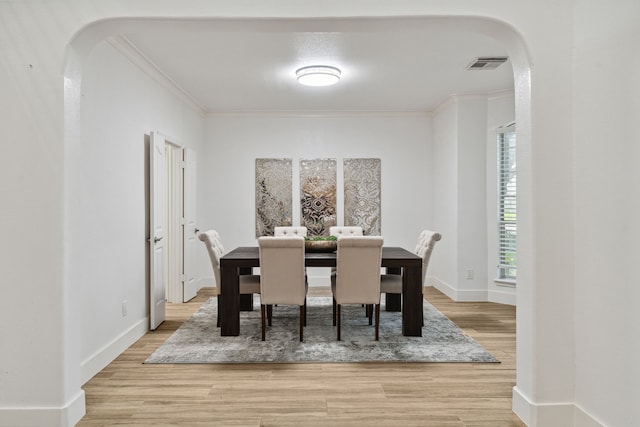 13826 Swan Hollow Ln, Houston, TX 77041 - dining area with arched walkways, crown molding, and light wood-style floors