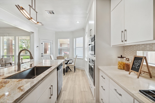 13826 Swan Hollow Ln, Houston, TX 77041 - kitchen featuring stainless steel appliances, tasteful backsplash, crown molding, white cabinetry, and light wood-style floors