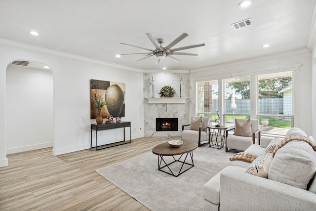 13826 Swan Hollow Ln, Houston, TX 77041 - living area with arched walkways, ornamental molding, wood finished floors, ceiling fan, and a premium fireplace
