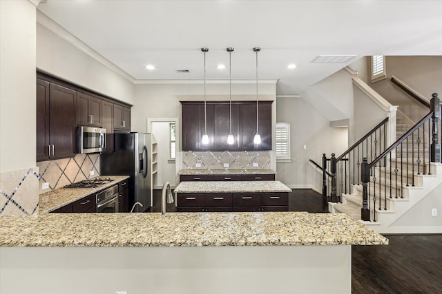4205 Dickson St, Houston, TX 77007 - kitchen featuring stainless steel appliances, dark brown cabinetry, tasteful backsplash, light stone countertops, and dark wood-style flooring