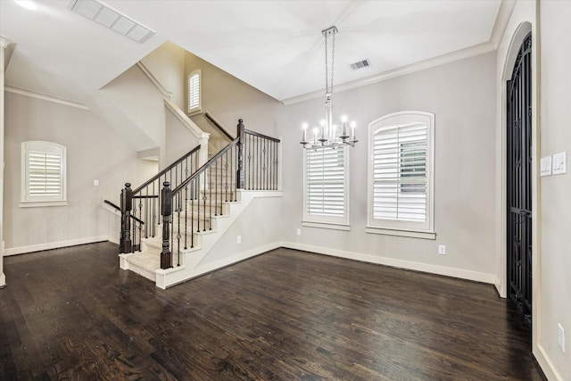 4205 Dickson St, Houston, TX 77007 - foyer featuring a chandelier, dark wood-style flooring, ornamental molding, and stairway