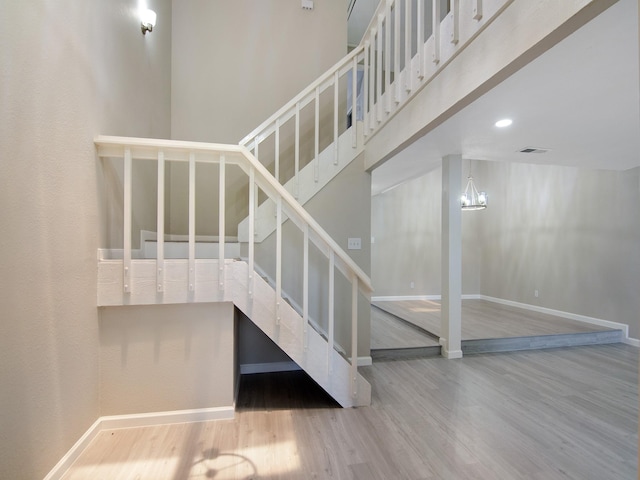 11624 Village Place Dr Unit 327, Houston, TX 77077 - stairway featuring wood finished floors, a chandelier, and recessed lighting