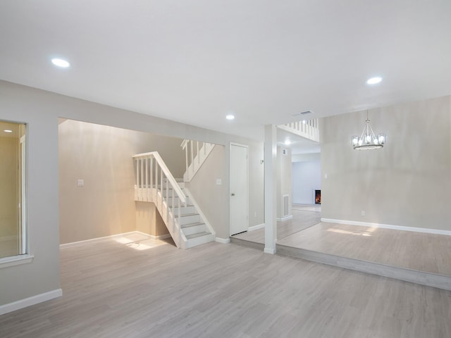 11624 Village Place Dr Unit 327, Houston, TX 77077 - below grade area with wood finished floors, stairs, recessed lighting, and a chandelier