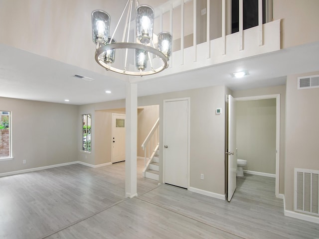 11624 Village Place Dr Unit 327, Houston, TX 77077 - unfurnished living room with a chandelier, stairway, a high ceiling, wood finished floors, and recessed lighting