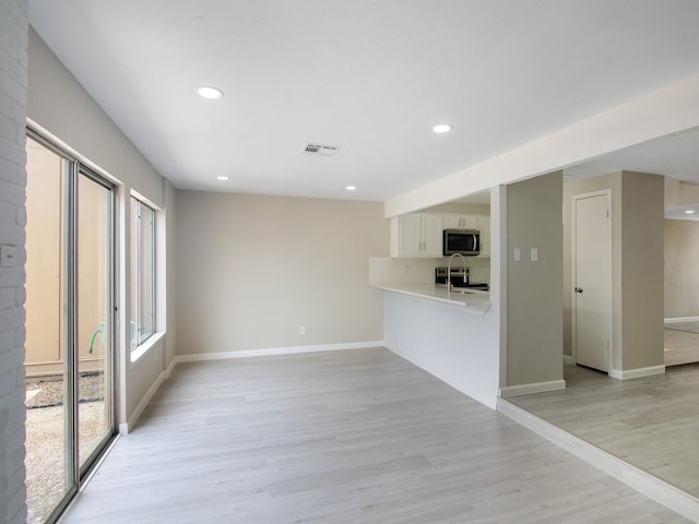 11624 Village Place Dr Unit 327, Houston, TX 77077 - unfurnished living room with recessed lighting and light wood-type flooring