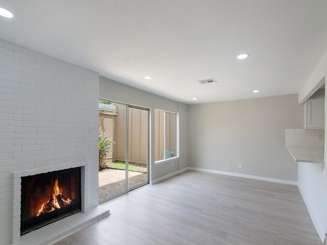 11624 Village Place Dr Unit 327, Houston, TX 77077 - unfurnished living room with light wood finished floors, a fireplace, and recessed lighting