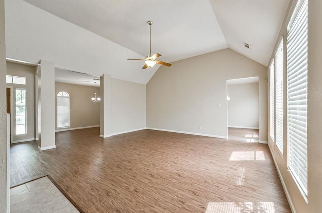 4611 Green Trail Dr, Houston, TX 77084 - unfurnished living room featuring a ceiling fan, vaulted ceiling, wood finished floors, and a chandelier