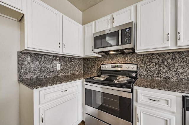 4611 Green Trail Dr, Houston, TX 77084 - kitchen with stainless steel appliances, white cabinets, and tasteful backsplash